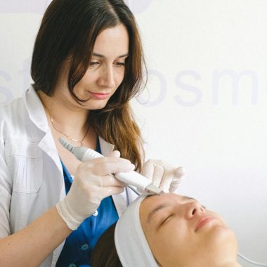 Cosmetologist doing facial treatment in beauty salon